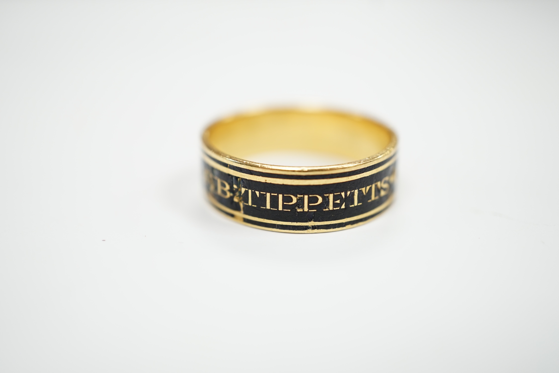 A George III yellow metal and black enamel set mourning band, inscribed ' J.B. Tippetts ob.28 June, 1782, ae.52', size P, gross weight 4.9 grams.